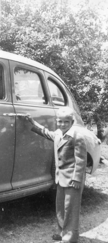 A young Bob Russell in front of a 1948 Nash Rambler